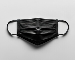 A black face mask, top-down view