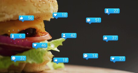 Showcasing cheeseburger with sesame bun and patty on wooden board, notification bubbles, copy space