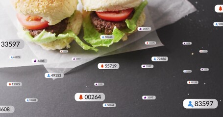 Showcasing slider burgers with sesame buns, lettuce, tomato on dark table with social overlay icons