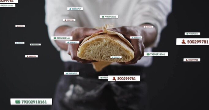 Holding adult male baker in dark apron presenting sliced bread in studio, with floating data labels - Powered by Adobe