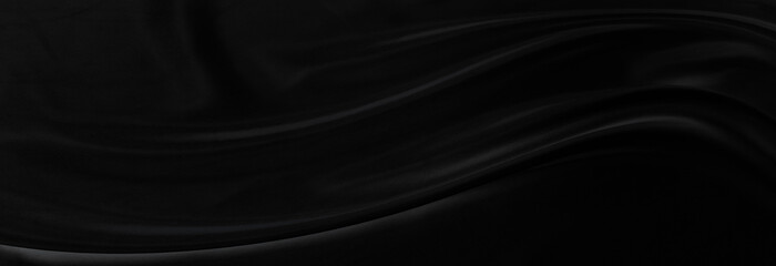 Black gray satin dark fabric texture luxurious shiny that is abstract silk cloth panorama background with patterns soft waves blur beautiful.