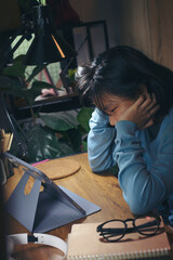 Asian children using digital tablet with stylus pen write and do homework at home. Stress Thai...