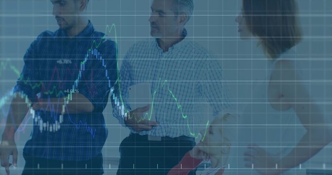 Four professionals in business attire discussing projections in boardroom with display, tablet