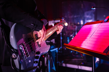 Musician Playing a Bass Guitar on Stage.