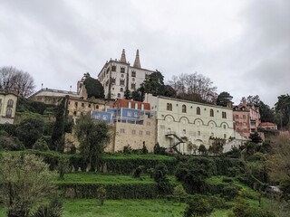White building on a hilltop surrounded by trees in Sintra, Portugal