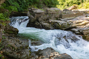 A picturesque rocky river with a waterfall.