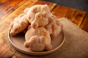 Pan de Muerto. Traditional Mexican sweet bread that is consumed in the season of the day of the dead. It is a main element in the altars and offerings in the festivity of Dia de Muertos in Mexico.
