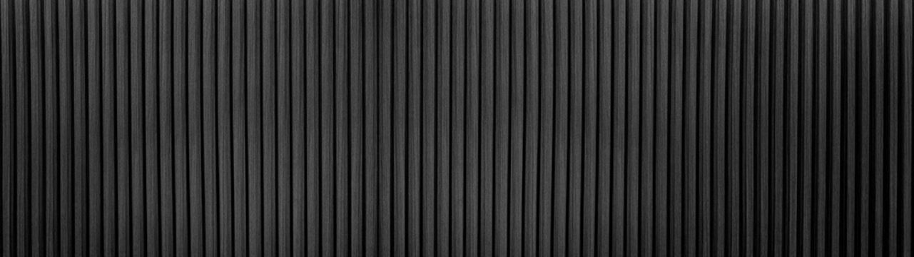 Dark Black Wood slat background use as banner in panorama long view. Grey wooden wall texture , seamless pattern. Modern ribbed wooden texture for design and decoration.