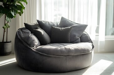 A fabric armchair with large cushions in light gray color in a calm atmosphere in a large room that enhances the beauty of the room, creating a pleasant atmosphere.