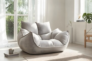A fabric armchair with large cushions in light gray color in a calm atmosphere in a large room that enhances the beauty of the room, creating a pleasant atmosphere.