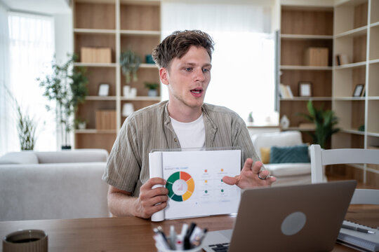 Businessman making video call and showing charts during a presentation