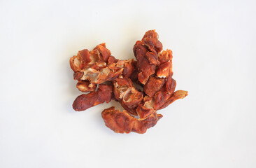 Peeled tamarind against white background, preparation process of tamarind for cooking. Top view.