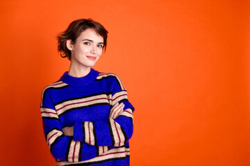 Photo of pretty lovely nice woman crossed arms wear trendy clothes empty space isolated on orange...
