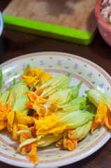 Fresh Edible Zucchini Blossoms on steel kitchen counter
