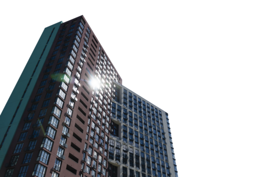 A low-angle view of a modern high-rise apartment building isolated on a transparent background with a bright sun flare