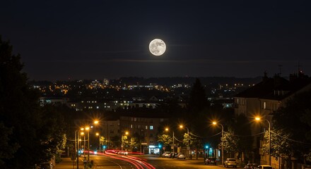 Full moon over city at night