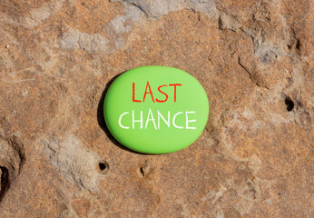 Last chance symbol. Concept word Last chance on beautiful green stone. Beautiful red brown stone...