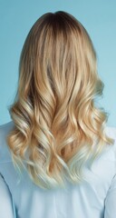 Naklejka premium Blonde highlights, wavy hair against light blue