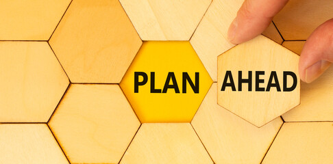 Plan ahead symbol. Concept word Plan ahead on beautiful wooden puzzles. Businessman's hand. Beautiful yellow paper background. Business plan ahead concept. Copy space.