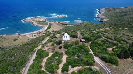 White chapel on Aegean island with blue sea background