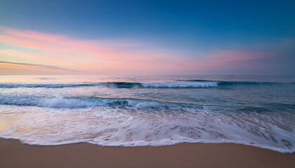 A Serene Beach Scene Featuring Gentle Waves Washing Ashore Under A Pastel Sky At Dusk