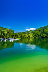 Amazing green Lake Plivsko jezero, Jajce, Bosnia and Herzegovina, wood reflection on water surface, popular tourist destination