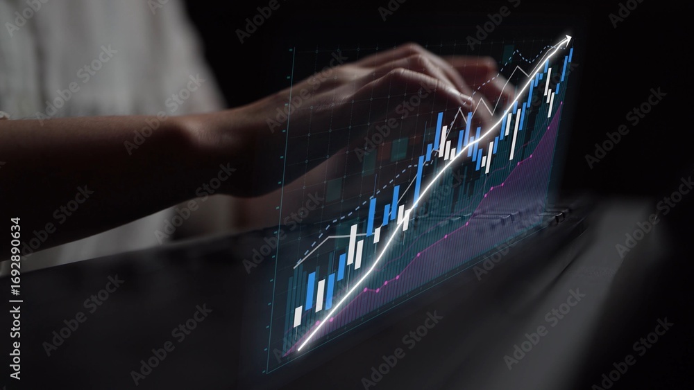 Poster a close-up view of a person typing on a laptop while analyzing financial data through graphs and cha