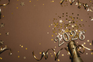 2026 New Year numbers with golden champagne bottle top view.