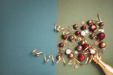 New Year or Christmas party background with golden champagne bottle and festive decoration. Trendy template for holiday celebration top view.