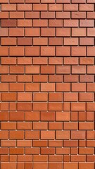 Fototapeta premium Vertical close-up of a brick wall, showing regular rectangular terracotta-colored bricks