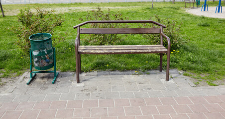 Rest area with bench surrounded by trees and ornamental shrubs in Kyiv, Europe. Place to rest in...