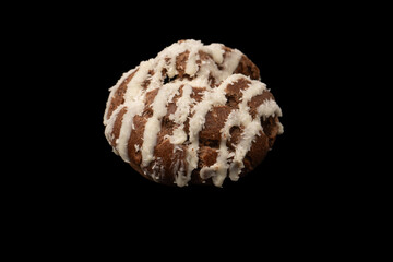Profiteroles with coconut cream on a black background.