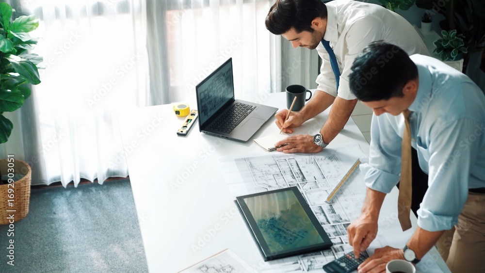 Aufkleber top view of manager talk and discussing about house construction while sit and write at blueprint at