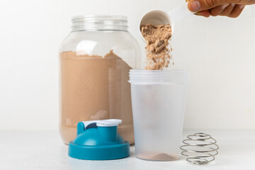 Protein powder. protein shake. Shaker bottle with protein. Food supplement. Whey protein powder with shaker for mixing. Sports nutrition. Concept of sports and healthy lifestyle. Sports equipment
