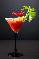 Bloody Mary cocktail with celery, lime, and red pepper.