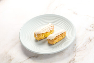 Delicous eclair with ising and cream