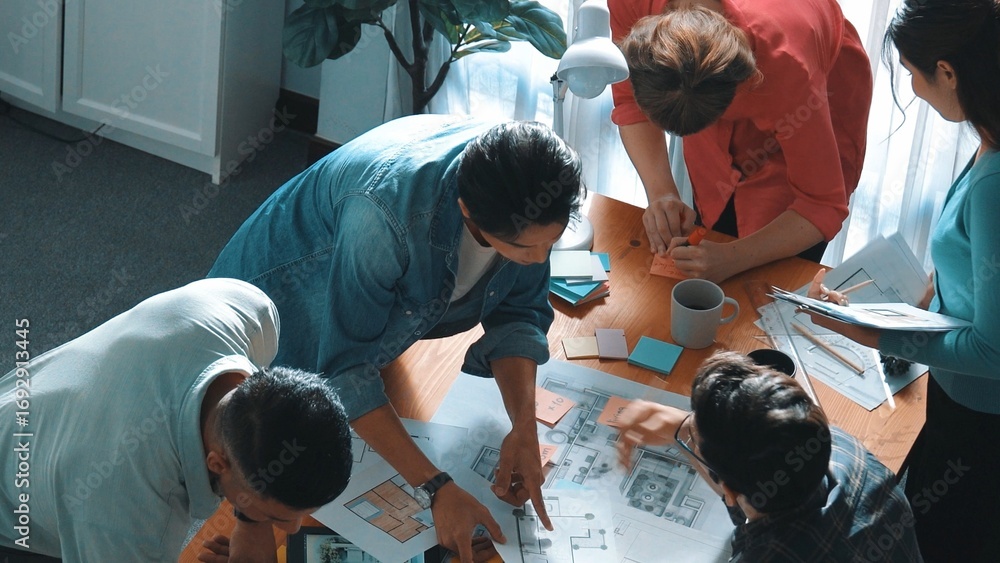 Poster top view of smart civil engineer looking project plan at meeting table while design building constru
