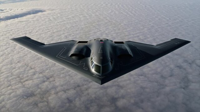 A b2 spirit stealth bomber soars through the sky above a thick layer of clouds, showcasing its unique design