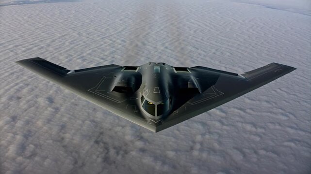 A b2 spirit stealth bomber glides through the air above a sea of clouds, displaying its distinctive shape
