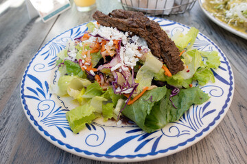 Healthy Steak Salad with Fresh Vegetables: Close-up of a healthy steak salad with mixed greens, cherry tomatoes, avocado, and grilled steak slices. Fresh, colorful, and nutrient-rich meal, perfect for