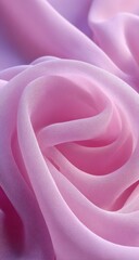 Obraz premium Close-up of soft, flowing, pink fabric. A close-up view of a delicate, light-pink fabric, exhibiting smooth folds and subtle ripples. The texture appears soft and luxurious
