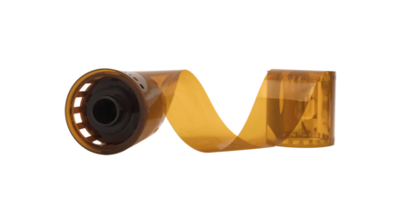 Camera film roll with its spool, still in its packaging, laying isolated on white background, png.