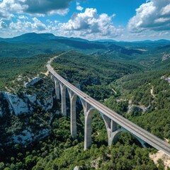 High-angle view of a long highway bridge arching over a valley