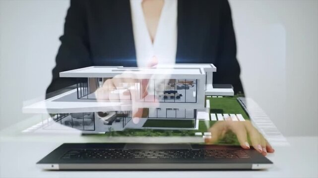 Real estate agent presenting a virtual 3D holographic model of a house. 
