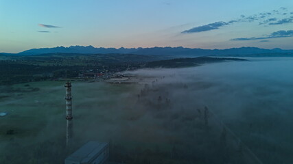 Abandoned Tower in Foggy Forest with Mountain Landscape