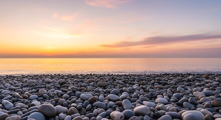 Beach pebbles at sunset with orange sky.