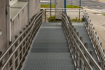 Obraz premium Accessible ramp for disabled people, metal ramp with handrails for strollers and disabled people,
