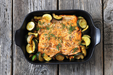 freshly baked salmon fillet with zucchini and dill