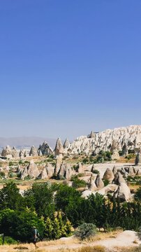 Panoramic View of Fairy Chimneys and Rock Formations in Cappadocia Under Clear Blue Sky