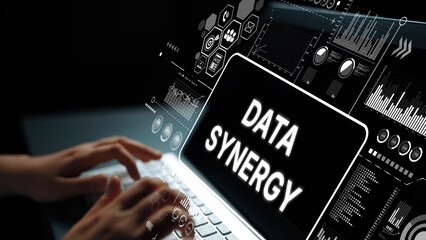 Hands Typing on Laptop with Data Synergy Graphics Showing Technology and Digital Analysis Concept....